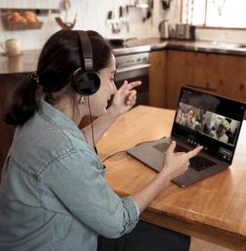 Young woman on laptop during a virtual meeting